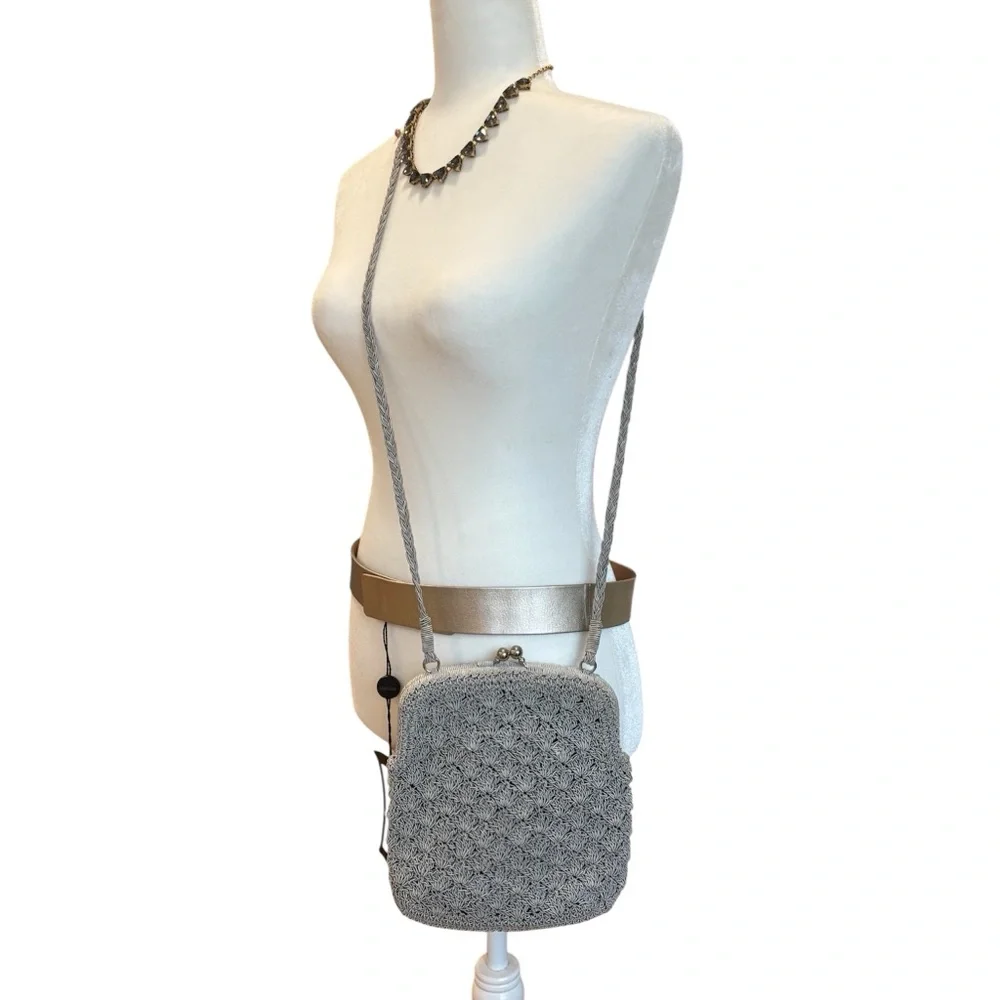 crocheted evening bag with a metal kiss-lock closure and braided shoulder strap